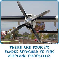There are four blades attached to this airplane propeller.